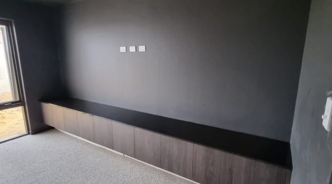 Theatre room . Cabinetry with stone